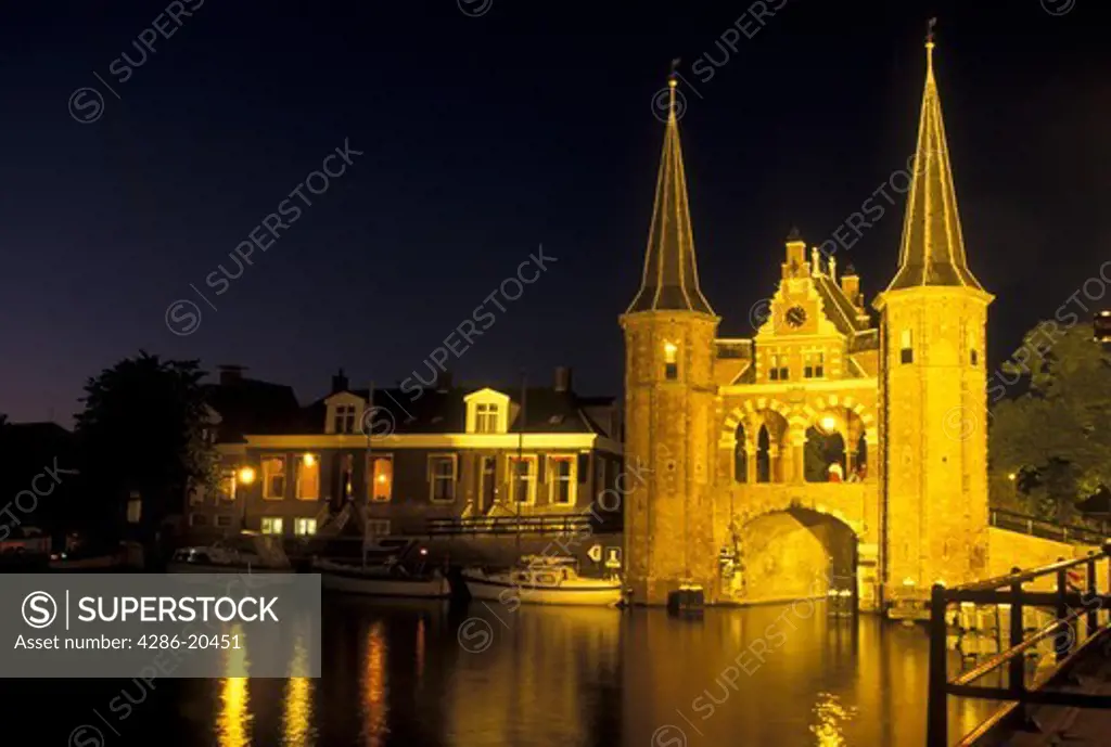 Netherlands, Sneek, Holland, Friesland, Europe, Water Tower (1613) along the canal in downtown Sneek illuminated at night.