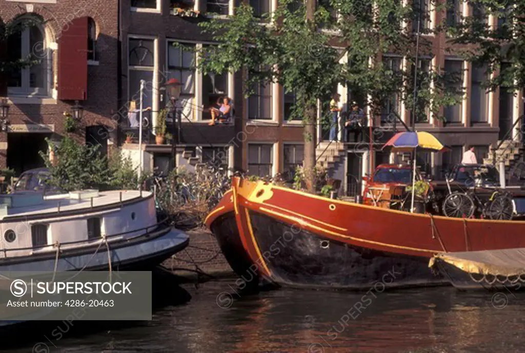 Amsterdam, Netherlands, Holland, Noord-Holland, Europe, Houseboats docked along a canal in Amsterdam.