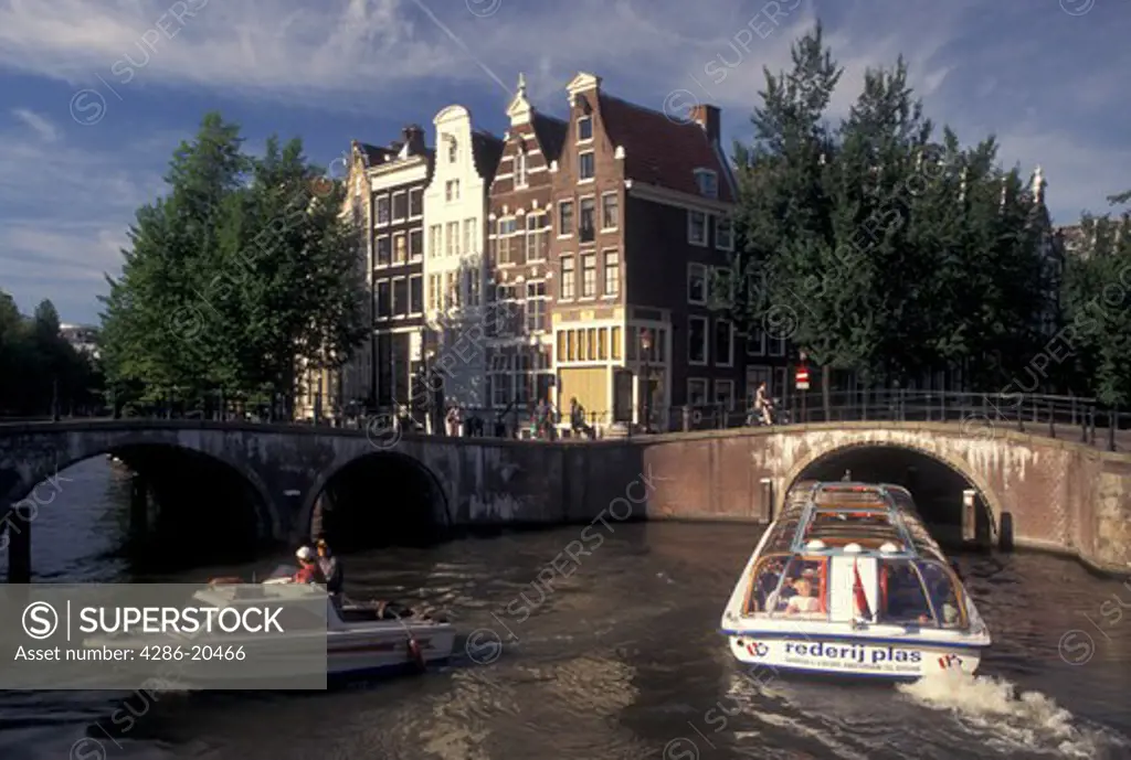 Amsterdam, Holland, Netherlands, Noord-Holland, Europe, Sightseeing tour boat cruises along a canal in Amsterdam.
