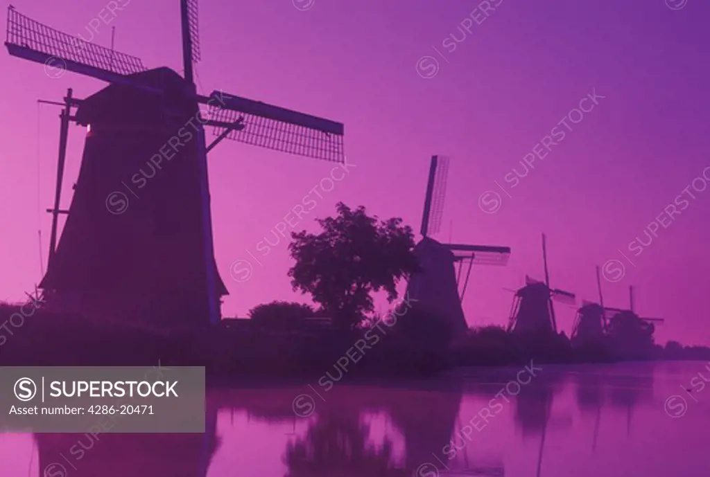 windmill, Kinderdijk, Netherlands, Holland, Zuid-Holland, Europe, Mills of Kinderdijk, Working windmills along a canal in the early morning mist in Kinderdijk. 