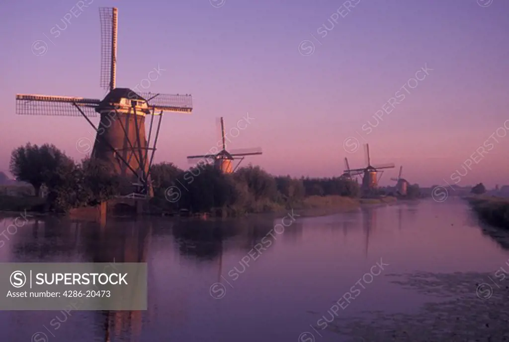 windmill, canal, Netherlands, Kinderdijk, Holland, Zuid-Holland, Europe, Mills of Kinderdijk, Working windmills along a canal in the early morning in Kinderdijk. 