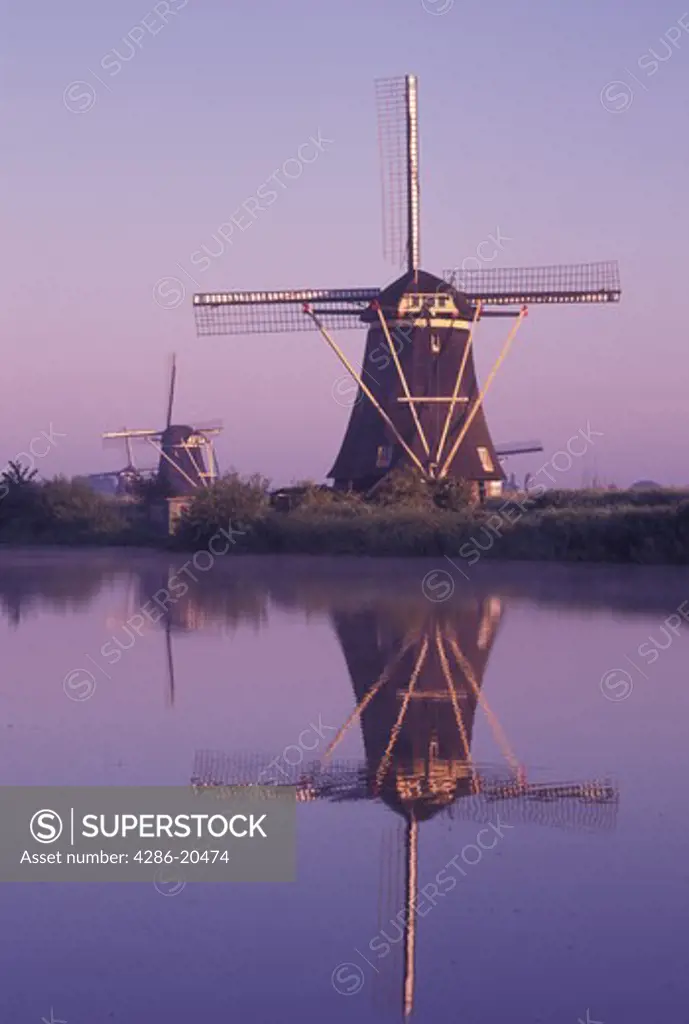 windmill, canal, Kinderdijk, Holland, Netherlands, Zuid-Holland, Europe, Mills of Kinderdijk, Working windmills along a canal in the early morning in Kinderdijk. 