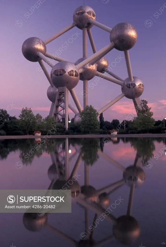 Brussels, Bruxelles, Belgium, Europe, Reflection of The Atomium, symbol of the 1958 World's Fair, a monument composed of nine giant metal spheres that represent the atoms of an iron molecule, in the water in the evening.