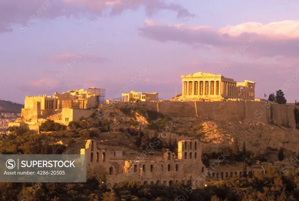 Athens, Greece, Europe, View of the Acropolis from Filopappos Hill at sunset.