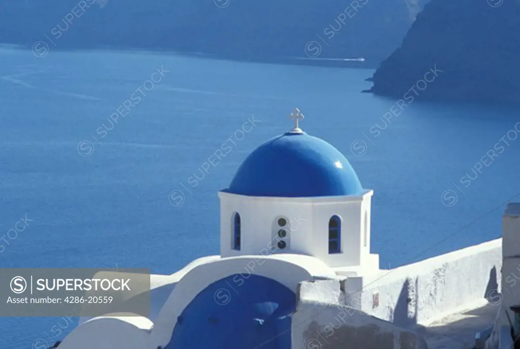 church, Greece, Santorini, Greek Islands, Oia, Cyclades, Europe, Whitewashed church with blue dome in the village of Oia overlooking the Aegean Sea on the island of Santorini.