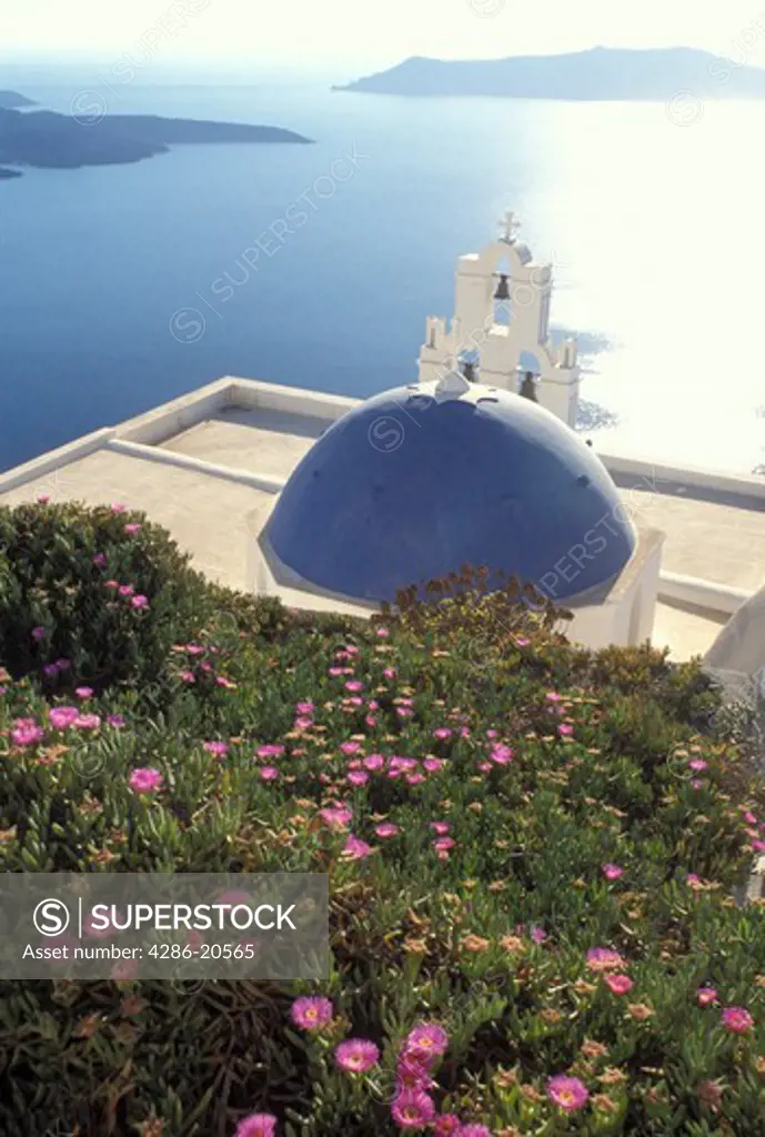 Santorini, Greek Islands, Fira, Cyclades, Greece, Europe, Whitewashed church with blue dome overlooking the Aegean Sea in the village of Fira on Santorini Island. 