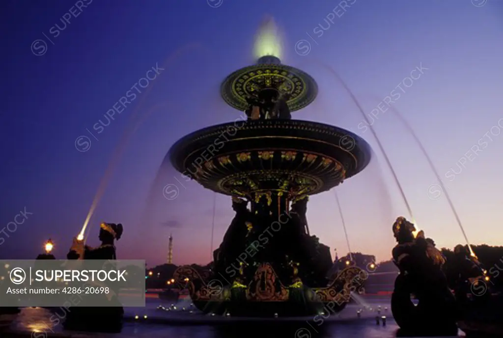 Paris, Ile de France, France, Europe, Fountain at Place de la Concorde in the city of Paris in the evening.