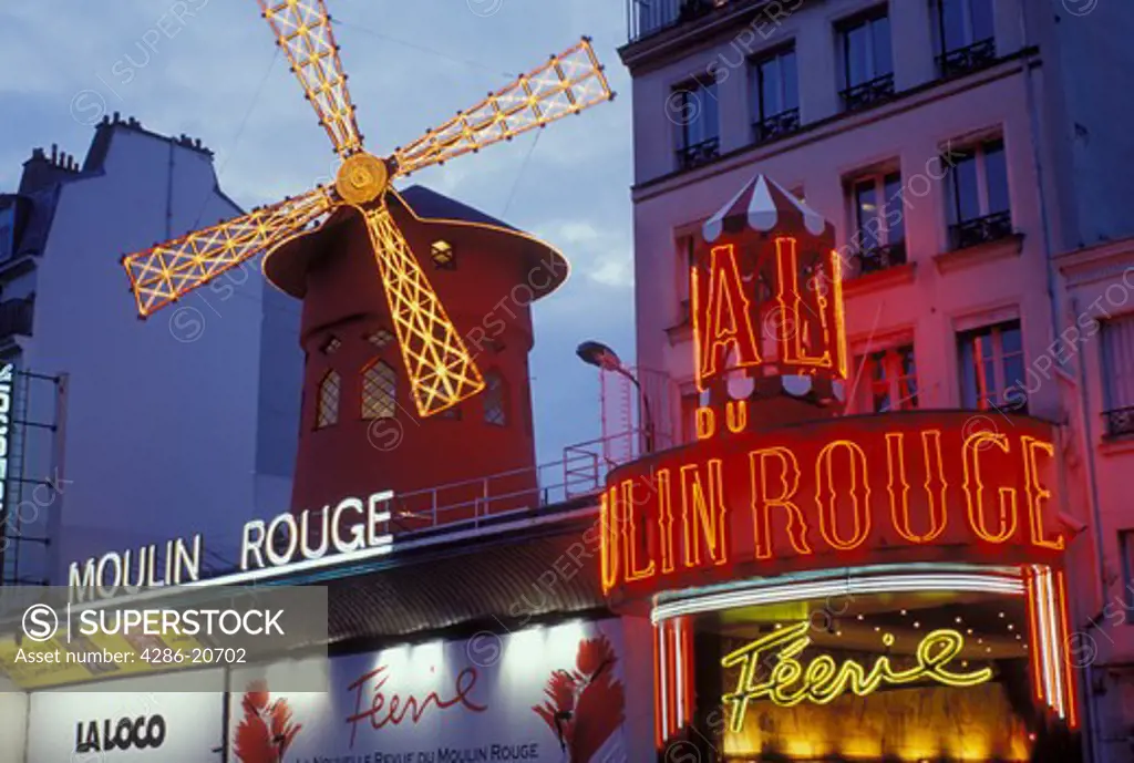 Paris, Ile de France, France, Europe, Moulin Rouge in the Pigalle Area of Paris in the evening. 