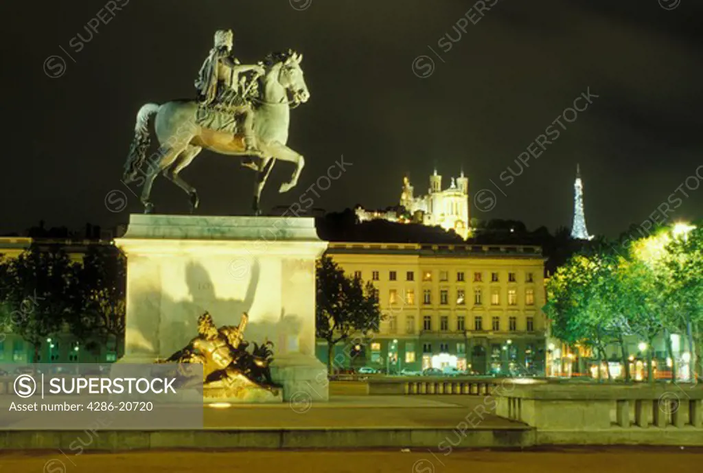 Lyon, France, Rhone-Alpes, Europe, Louis XIV statue illuminated at night in Place Bellecour in downtown Lyon.