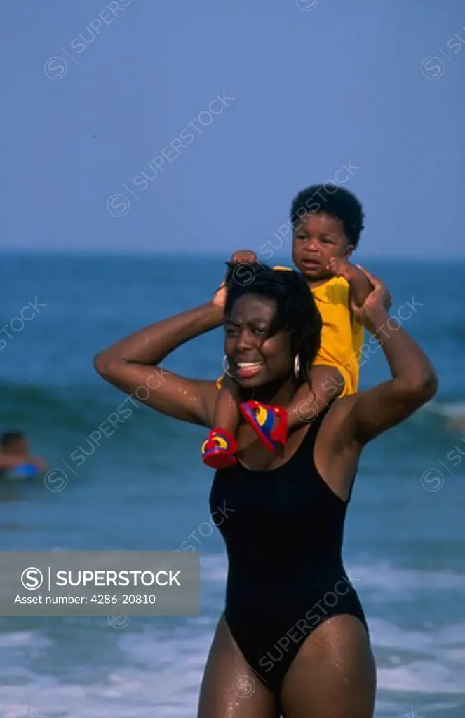 Black mother and son at beach #1