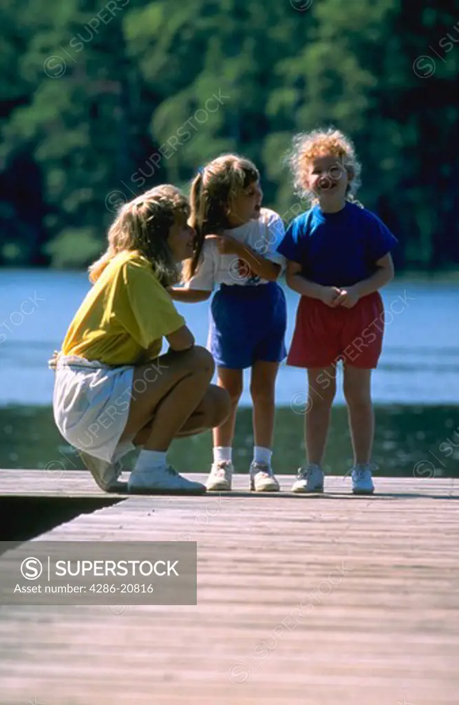 Mother and 2 daughters on pier