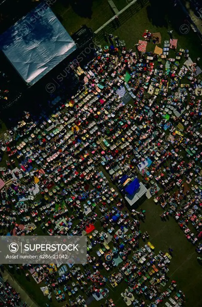 Aerial view of crowd on a sunny day attending an outdoor concert in Northwestern Florida.