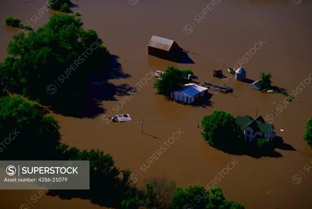 Aerial view of a farm being flooded by the Iowa River.