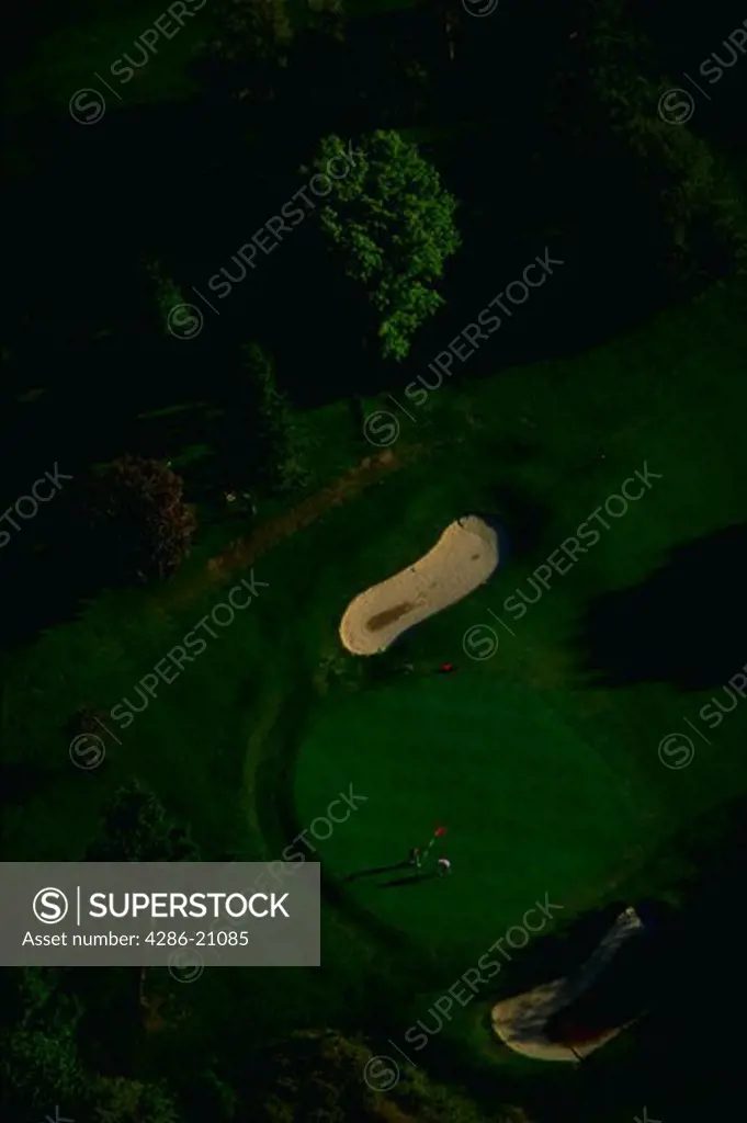 Aerial view of a putting green and bunkers at a golf course in Chevy Chase, Maryland with golfers on the green.