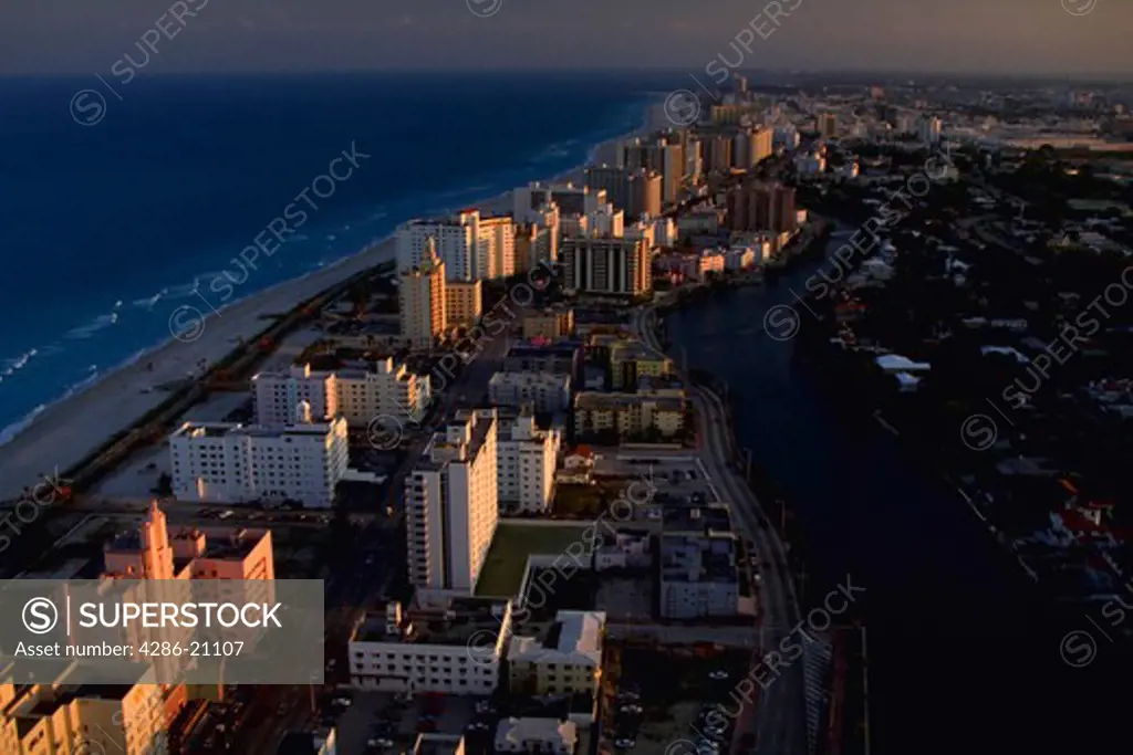 Aerial view of sunset in Miami Beach, Florida with the Atlantic Ocean and Intercoastal Waterway in view.