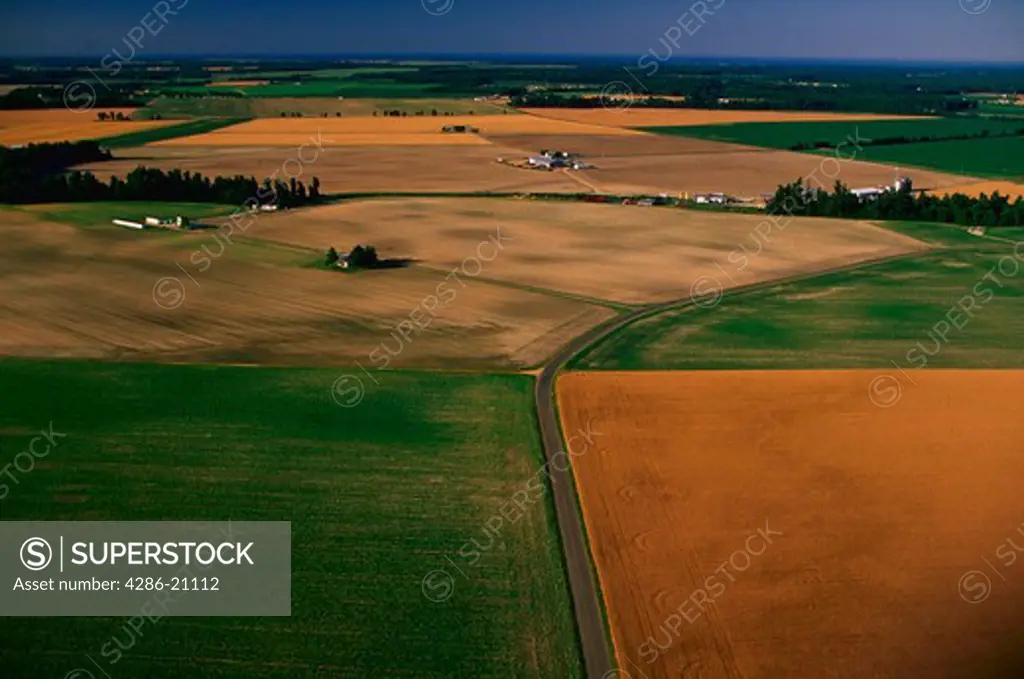 Aerial view of brown and green agricultural fields.