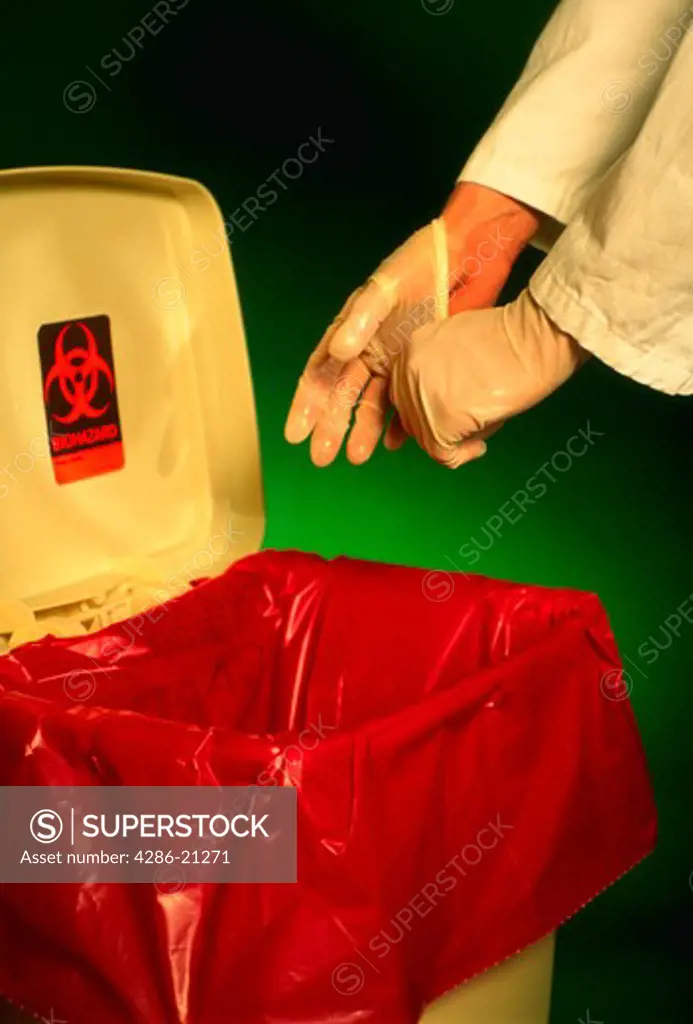 Latex gloves being disposed of into biohazardous waste container.MR
