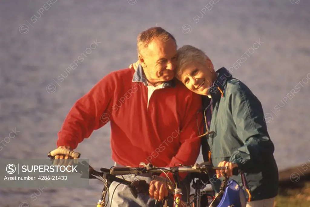 Senior couple, love, bicycle in park