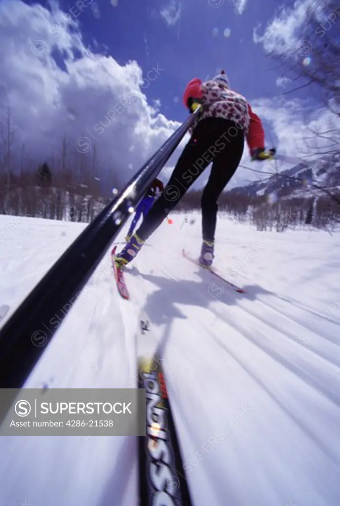 A blurry shot of a woman cross country skiing at Sundance, UT.