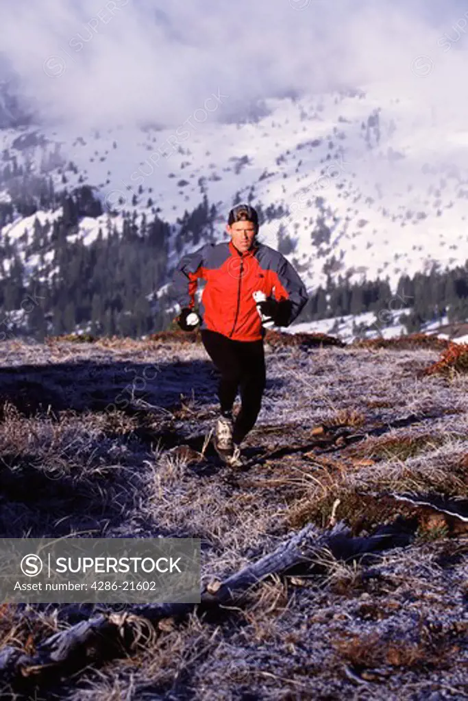 A man running in the back country in winter in the Sierra mountains of California..