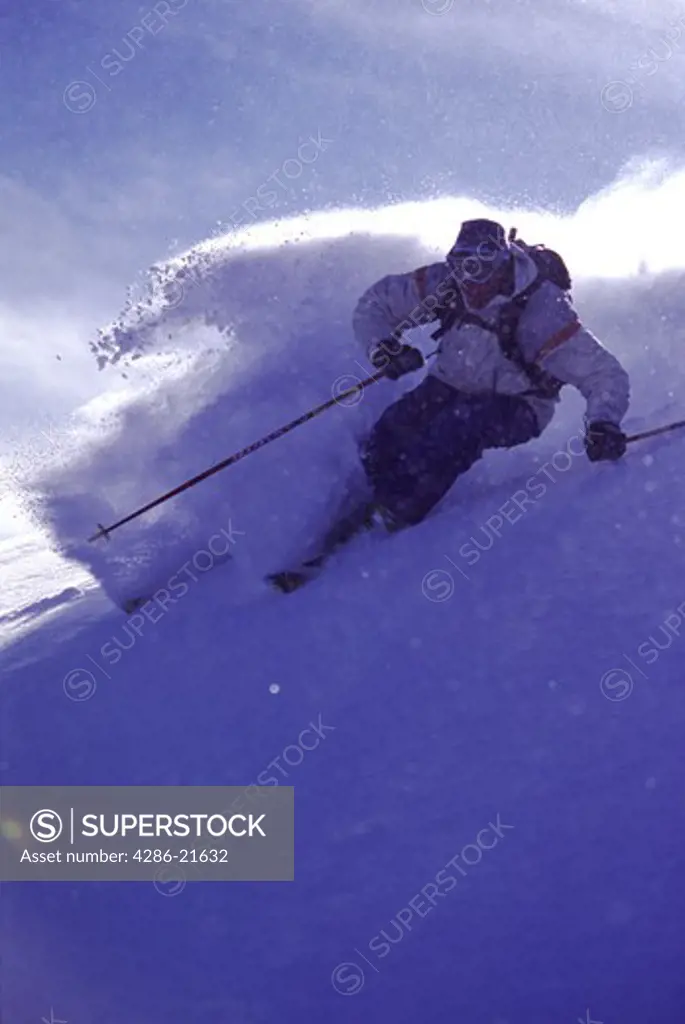 A man skiing powder snow in the Utah backcountry.