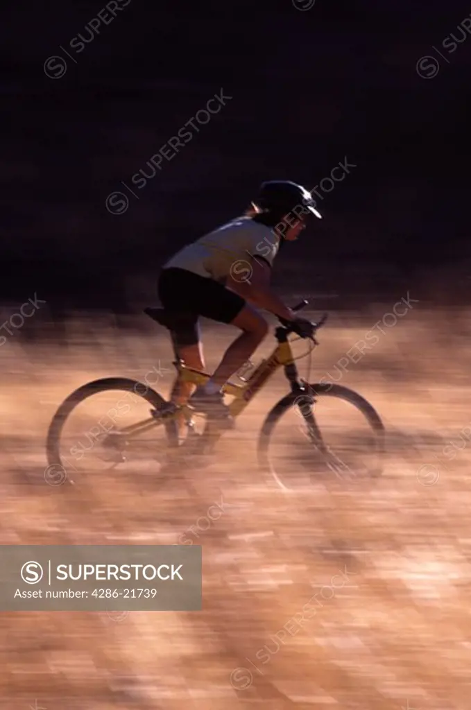 A woman mountain biking a dusty trail on Donner Summit, CA.