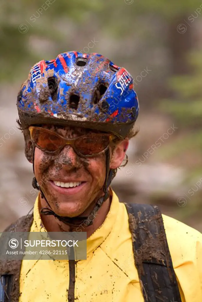 A muddy man taking a break while mountain biking near Truckee, CA.