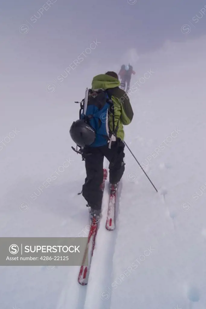 Two ski mountaineers climbing Mt. Vsevidov in the Aleutian islands.