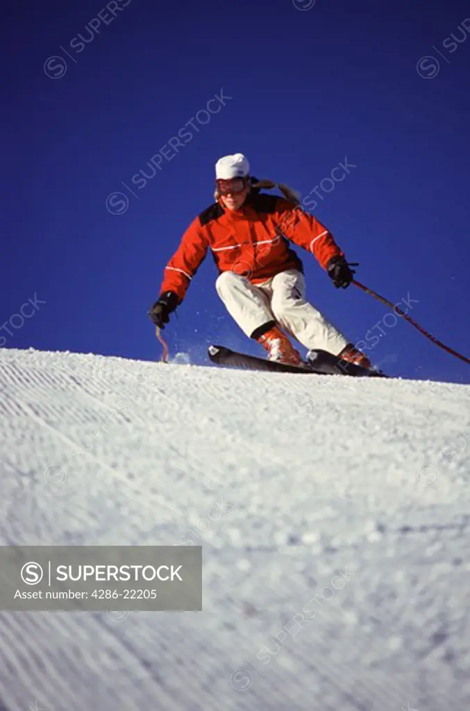 A woman skiing on corduroy at Alpine Meadows, CA.