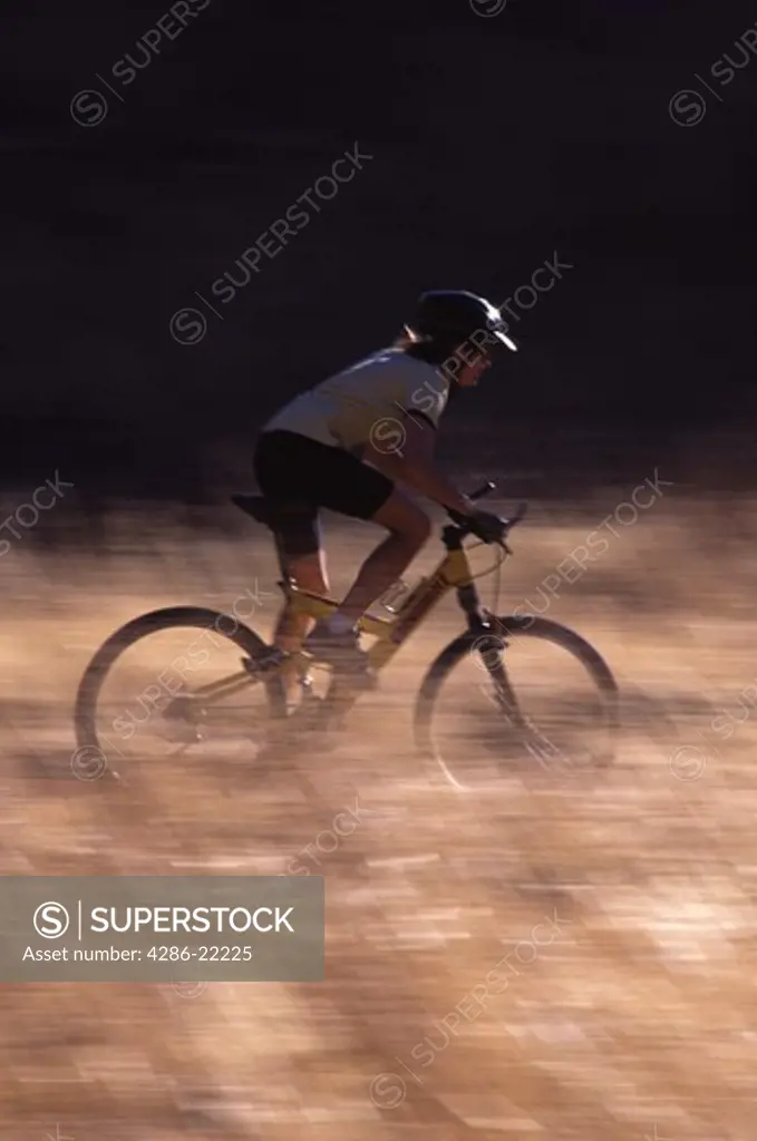 A woman mountain biking a dusty trail on Donner Summit, CA.