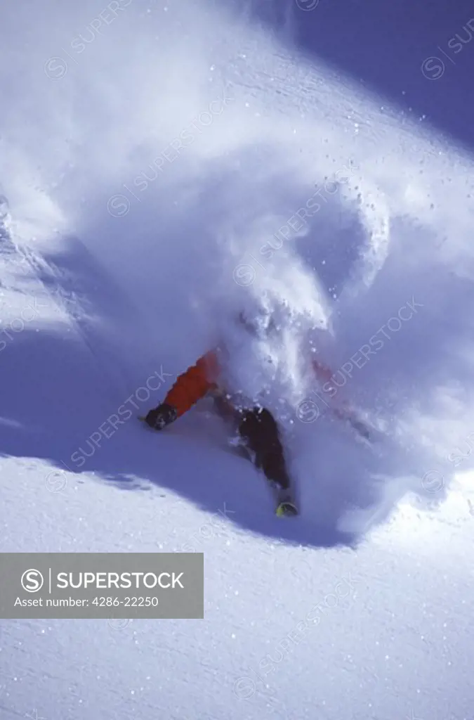 A man skiing powder in the Chugach Mountains, AK