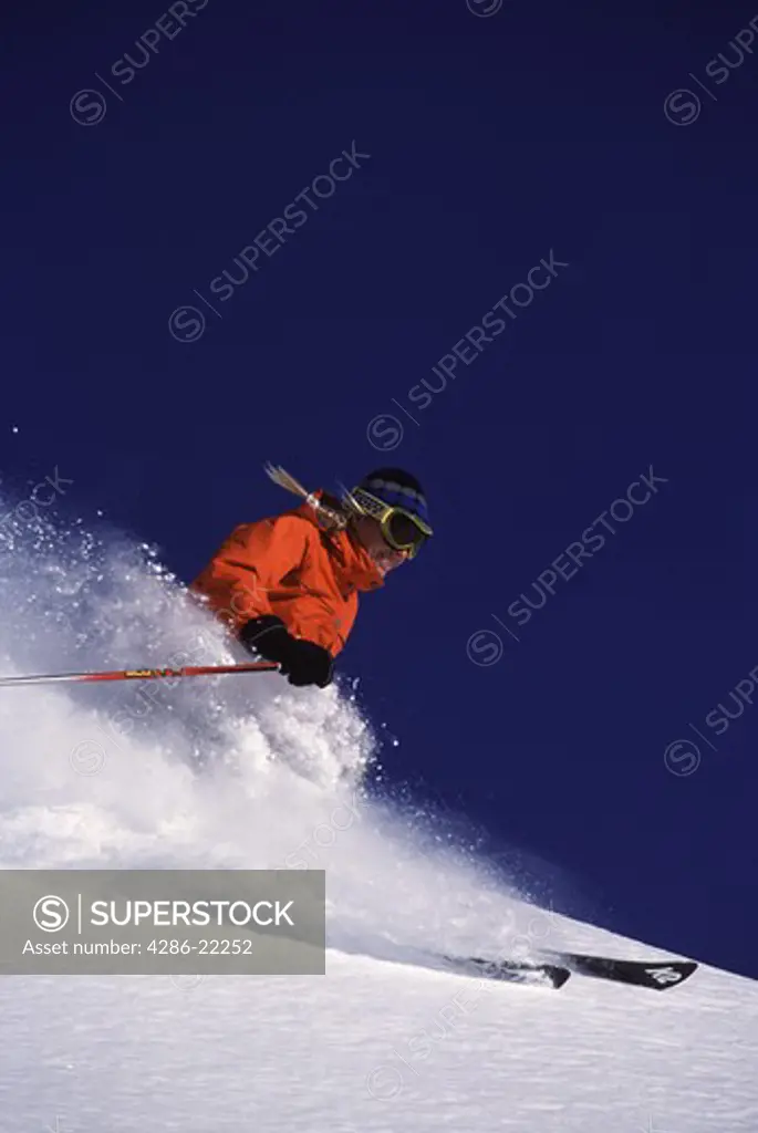 A woman skiing powder at Alpine Meadows, CA.