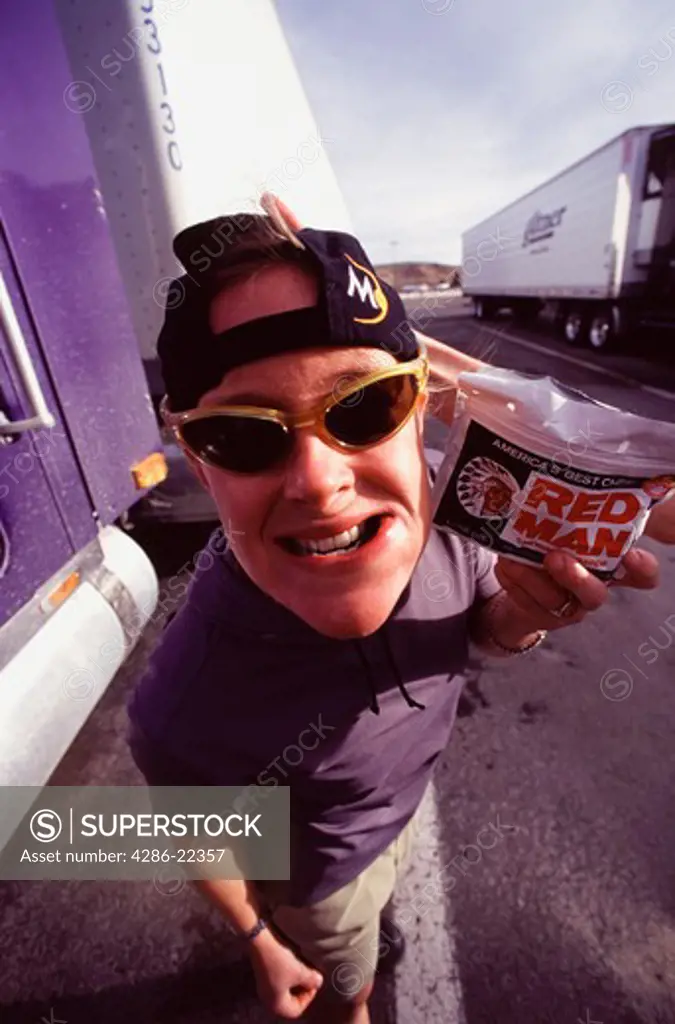 A woman truck driver chewing tobacco. 