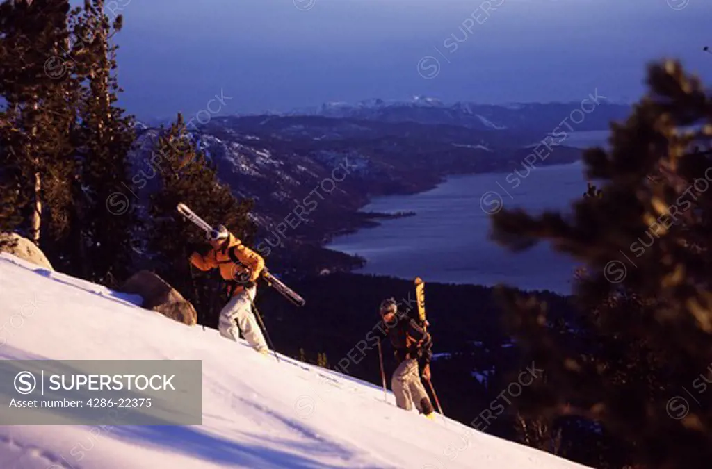 A couple ski mountaineering above Lake Tahoe, CA.