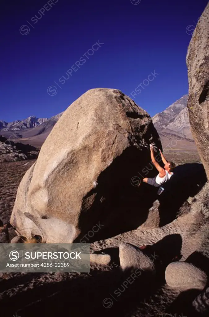 A man bouldering at The Buttermilks, CA.