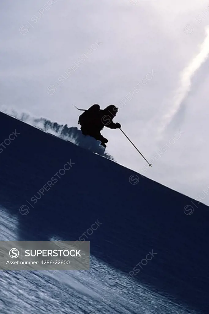 A man skiing powder snow in the Wasatch mountains of Utah.