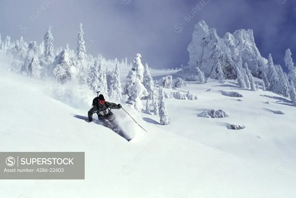 A man skiing powder snow at Squaw Valley in California.