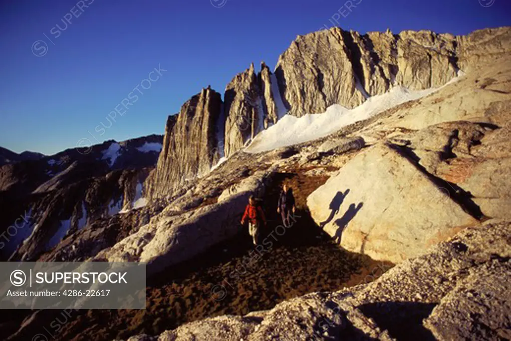 Two people hiking in the Sierra mountains of California.