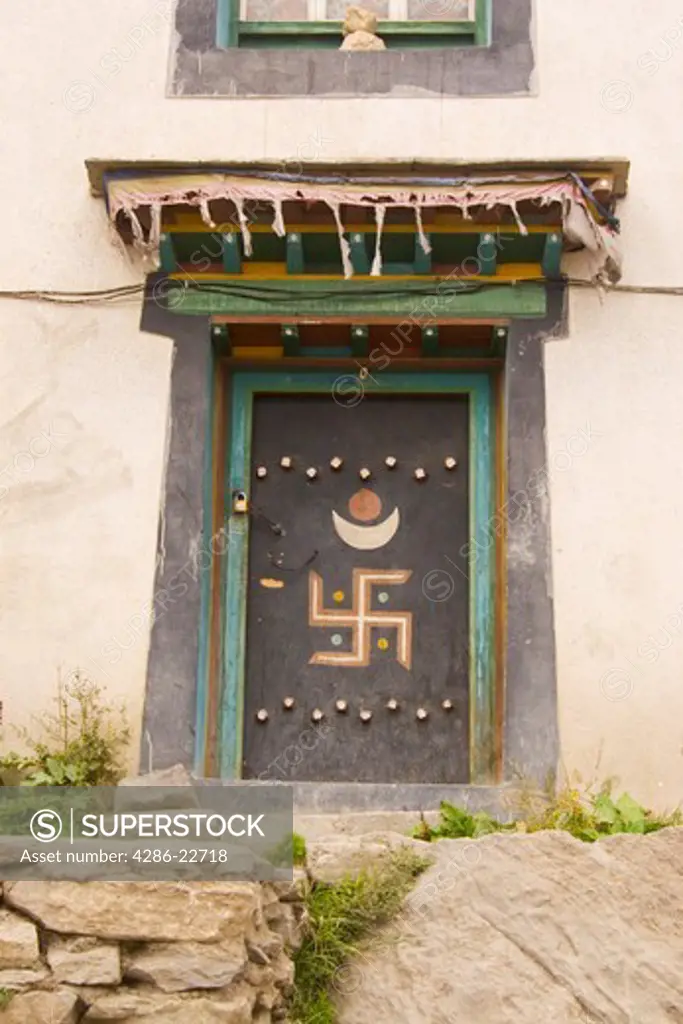 A Tibetan Swastika on a door in the town of Nyalam in Tibet, China