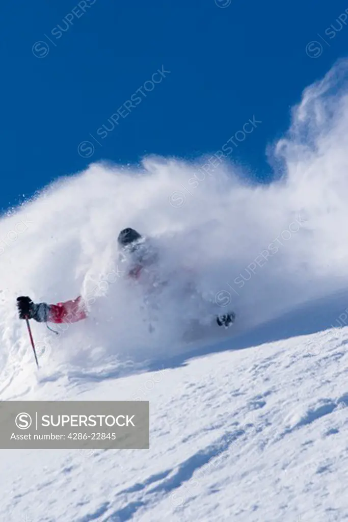 A Squaw Valley ski patroller skiing deep powder snow at Squaw Valley in California