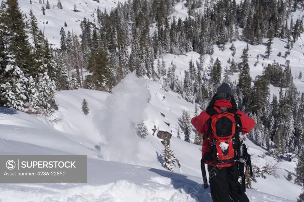 A ski patroller throwing explosives for avalanche control at Squaw Valley in California.