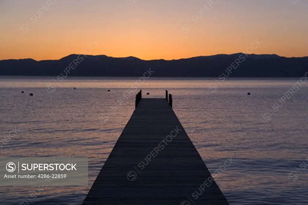 A boat dock on Lake Tahoe at sunrise.