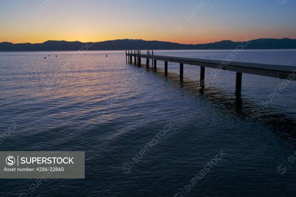 A boat dock on Lake Tahoe at sunrise.