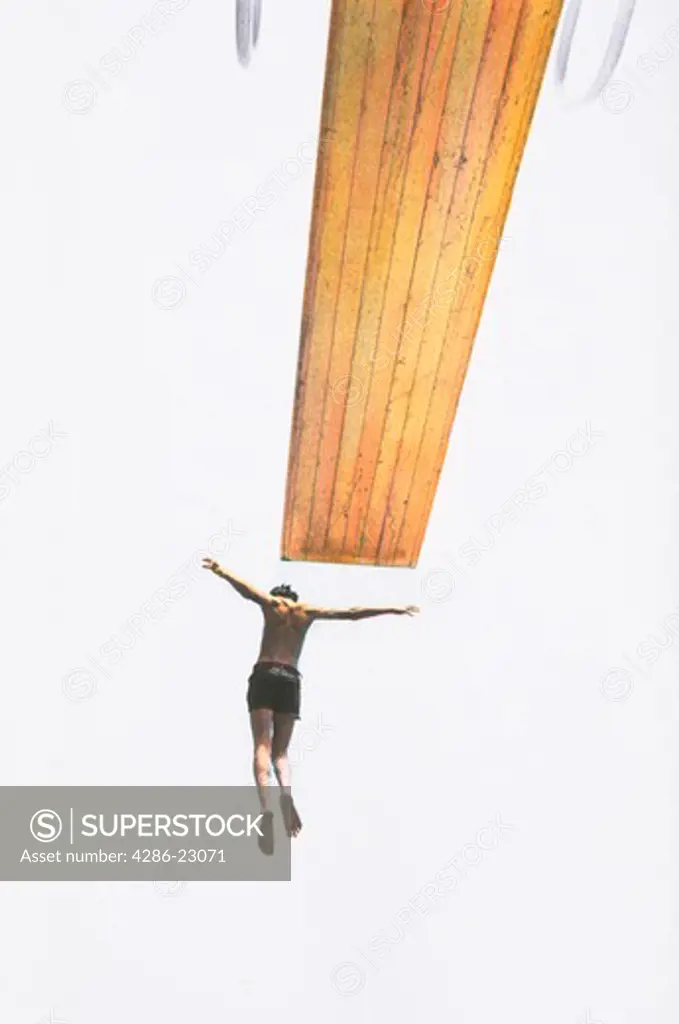  Hand colored image of 12 yo boy jumping off diving board simile to crucifixion