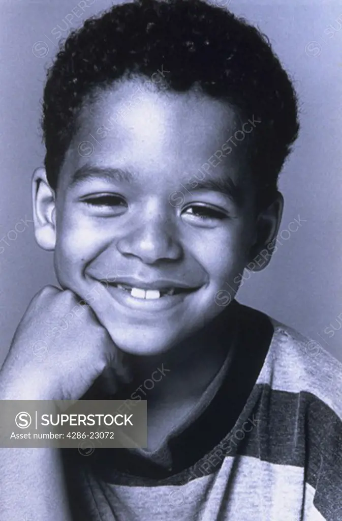 B/W . Portrait of 6-8yo black boy smiling