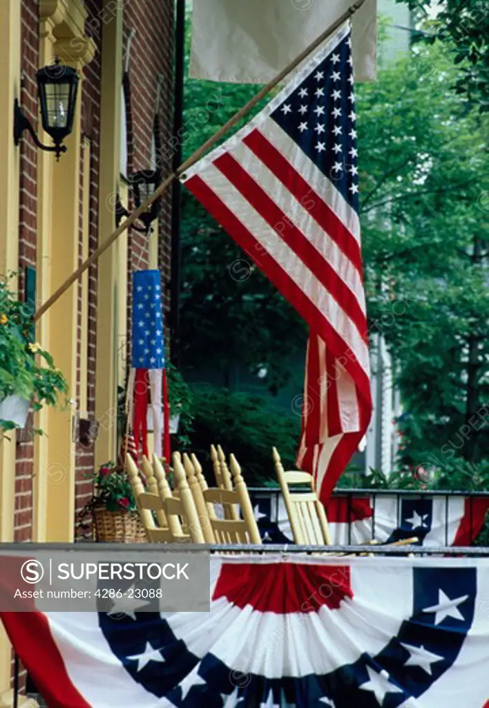American flag and bunting hanging on the front porch of a house in Chautauqua, New York.