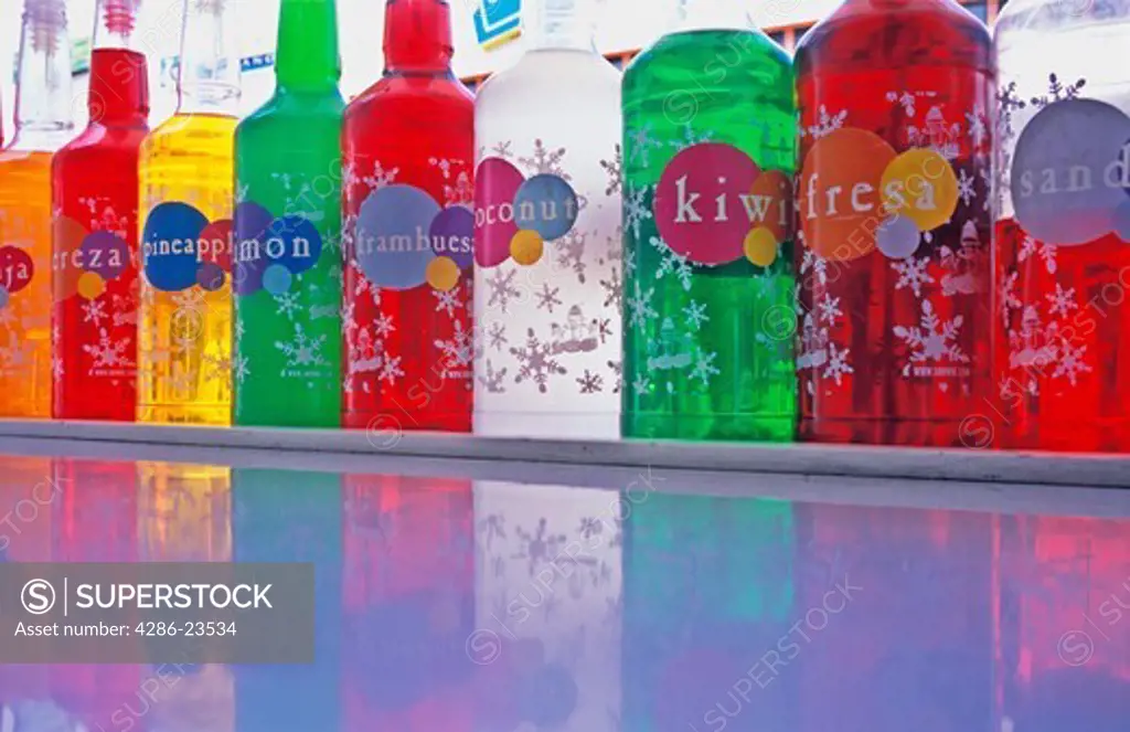 different colored bottles of flavored drink syrup