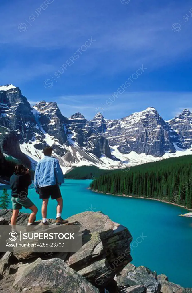 Canada Alberta Banff National Park Moraine Lake and the Valley of the Ten Peaks with a young couple admiring the scene