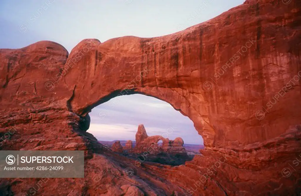 USA, Utah, Arches National Park, view of Turret Arch through the North Window at sunrise