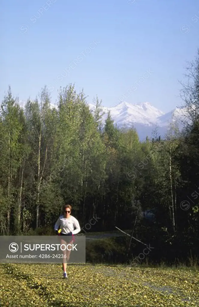Jogger, on Tony Knowles Coastal Trail, Earth Quake Park, Anchorage, Alaska.